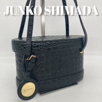 ジュンコシマダ JUNKO SHIMADA バニティバッグ ハンドバッグ 円形ボックス クロコ型押し レザー 本革 ブラック 黒 チャーム付き レディース